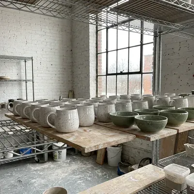 Freshly glazed pieces cooling on ware boards